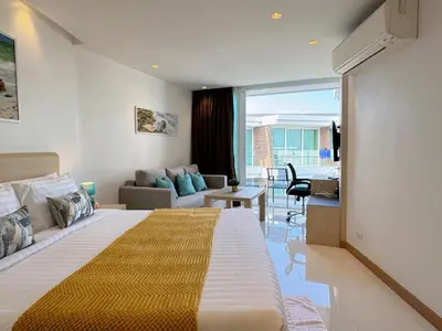 a hotel room with a bed and a living room at Cozy Studio Rawai Beach Phuket in Ban Saiyuan (1)