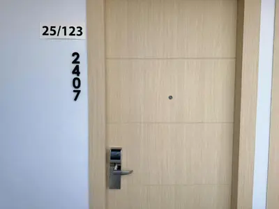 a door with a clock on the side of it at Cozy Studio Rawai Beach Phuket in Ban Saiyuan (1)