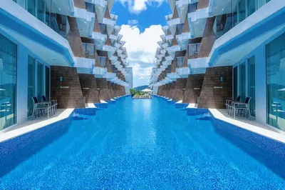 a swimming pool in the middle of a building at Cozy Studio Rawai Beach Phuket in Ban Saiyuan (1)