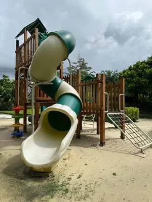a slide on a playground in a park at Laguna Skypark, 2 bedrooms & large terrace with golf view in Phuket Town