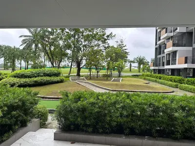 a view of a park with trees and a building at Laguna Skypark, 2 bedrooms & large terrace with golf view in Phuket Town