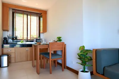a kitchen with a desk and a table with a chair at 208 Ao Nang, Private Sea View Pool Villa in Krabi town