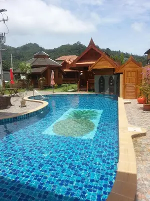 a pool at a resort with a turtle in the water at Golden Teak Resort Baan Sapparot in Kamala Beach