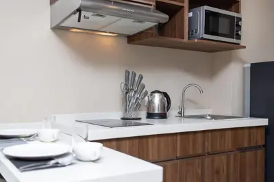 a kitchen with a sink and a microwave at Nai Harn Beach Condominimum in Phuket Town