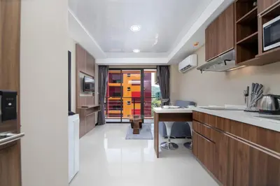 a kitchen with a table and a desk in it at Nai Harn Beach Condominimum in Phuket Town