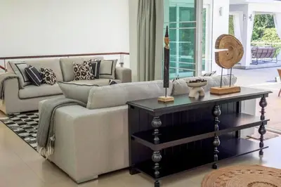 a living room with a couch and a table at Luxurious 5 bedroom 5 bathroom Gym Views v138 in Kamala Beach
