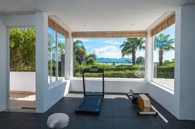 a room with a large window and a treadmill at Phuket 4-6 Bedroom Seaview Villa Infinity 25mPool In-Villa Dining & Butler Gym in Thalang