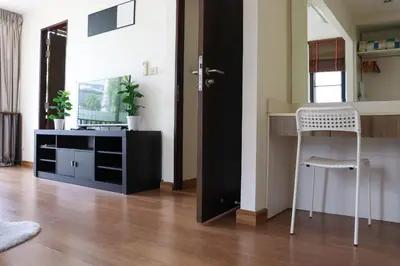 a room with a table and a chair and a desk at Happy House in Laguna Park in Laguna Phuket