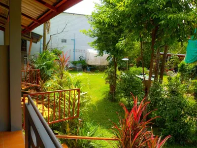 a view of a garden from the balcony of a house at Bonus Bungalow in Chalong