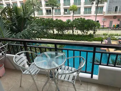 a table and chairs on a balcony with a swimming pool at Phuket Villa Patong,Pool View in Patong Beach