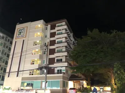 a tall white building at night at Phuket Villa Patong,Pool View in Patong Beach