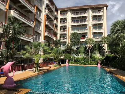 a swimming pool in front of a large building at Phuket Villa Patong,Pool View in Patong Beach