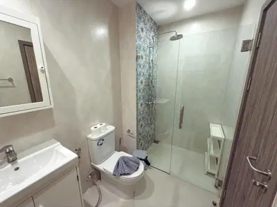 a bathroom with a shower and a toilet and a sink at The Title Residencies Naiyang by Mill in Nai Yang Beach