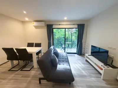 a living room with a couch and a table at The Title Residencies Naiyang by Mill in Nai Yang Beach