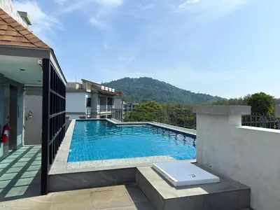 a swimming pool on the side of a house at The Title Residencies Naiyang F by Mill in Nai Yang Beach