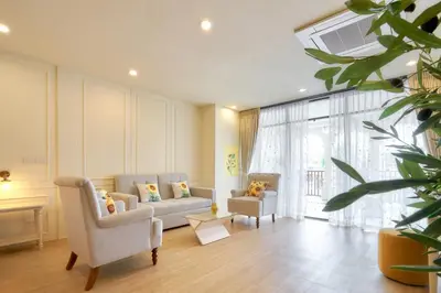 a living room with a couch and two chairs at Hawa House Phuket in Phuket Town