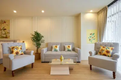 a living room with two couches and a coffee table at Hawa House Phuket in Phuket Town