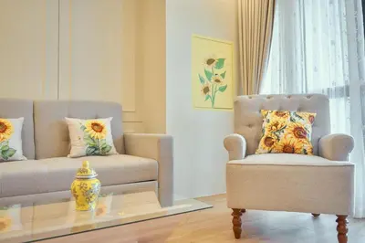 a living room with a couch and a chair and a table at Hawa House Phuket in Phuket Town