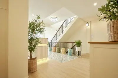 an open hallway with stairs and potted plants at Hawa House Phuket in Phuket Town