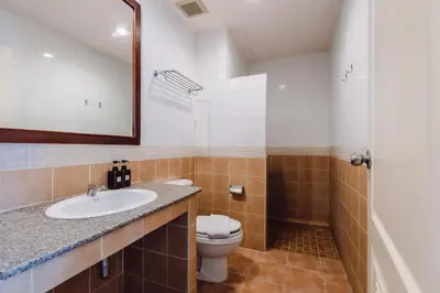 a bathroom with a sink and a toilet at Bauman-Ville Hotel Patong in Patong Beach