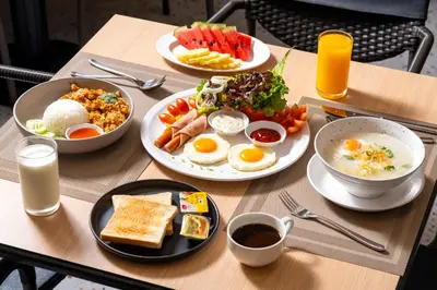 a table with plates of breakfast food on it at Horange Phuket Town in Phuket Town