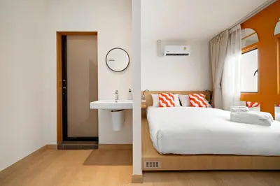 a hotel room with a bed and a sink at Horange Phuket Town in Phuket Town
