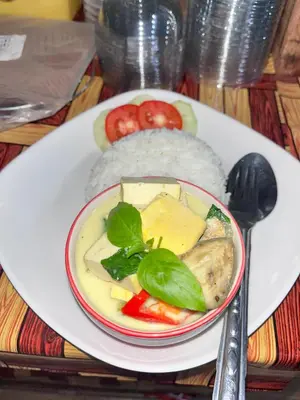 a plate of food with cheese and vegetables on a table at Mukda in Ko Yao Noi