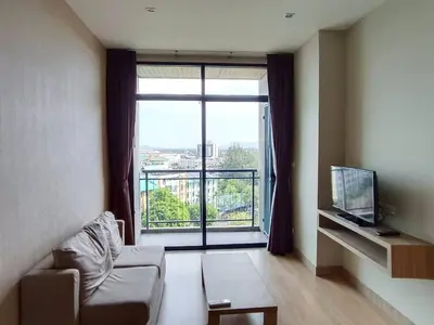 a living room with a couch and a large window at Condo 1 bed in Phuket City Center 8th Floor in Ban Rangeng