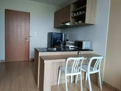 a kitchen with two chairs and a counter with a sink at Condo 1 bed in Phuket City Center 8th Floor in Ban Rangeng