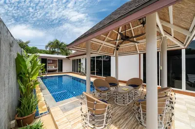 an outdoor patio with a swimming pool and a house at Bangtao villa 3 bedroom in Phuket Town