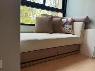 a bench with a window in a room at Zcape X2 boat avenue by sahana in Bang Tao Beach