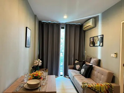 a living room with a couch and a table at Zcape X2 boat avenue by sahana in Bang Tao Beach