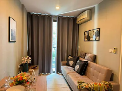 a living room with a couch and a table at Zcape X2 boat avenue by sahana in Bang Tao Beach