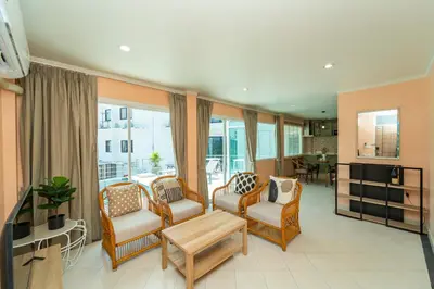 a living room with chairs and a table at Nature's Hideaway by Ratana, Rawai in Ban Saiyuan (1)