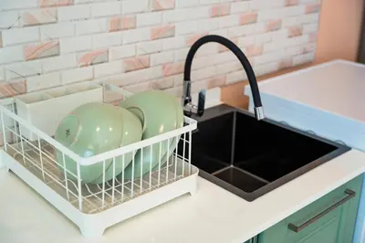 a kitchen sink with a dish drying rack next to it at Nature's Hideaway by Ratana, Rawai in Ban Saiyuan (1)