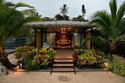 a resort with a pathway leading to a house with a thatch roof at Big Sun Residences By iRETREAT in Ko Yao Noi