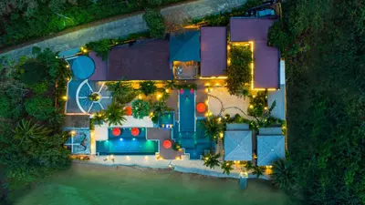 an aerial view of a house with a pool at night at Big Sun Residences By iRETREAT in Ko Yao Noi