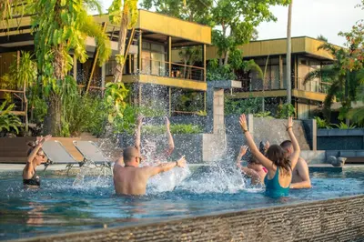 a group of people playing in a fountain in a swimming pool at Big Sun Residences By iRETREAT in Ko Yao Noi