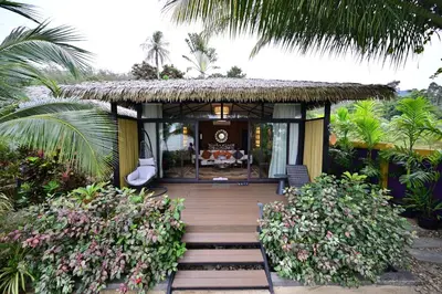 a small house with a thatched roof at Big Sun Residences By iRETREAT in Ko Yao Noi