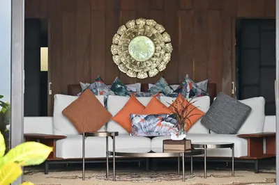 a living room with a couch with pillows on it at Big Sun Residences By iRETREAT in Ko Yao Noi