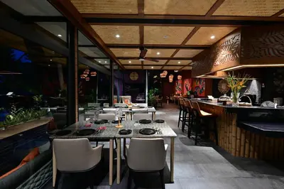 a restaurant with tables and chairs and a bar at Big Sun Residences By iRETREAT in Ko Yao Noi