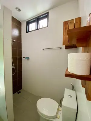 a bathroom with a toilet and a shower at Maria's Guest House, Rawai in Rawai Beach