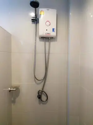a shower in a bathroom with aperature at The Seashore Kamala Service Apartment in Kamala Beach