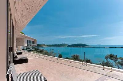 a view of the ocean from the balcony of a house at Villa W Collection in Nai Harn Beach