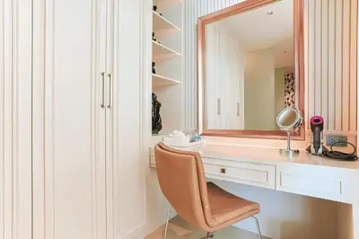 a bathroom with a desk with a mirror and a chair at Villa W Collection in Nai Harn Beach