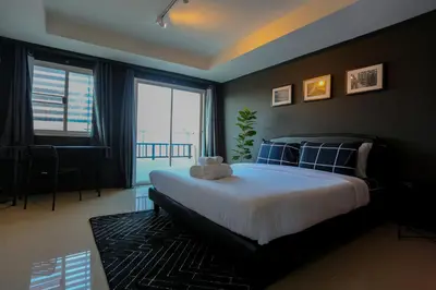 a bedroom with a large bed and a large window at Black Turtle in Koh Lone