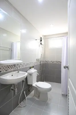 a white bathroom with a toilet and a sink at Black Turtle in Koh Lone