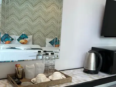 a kitchen counter with a coffee maker and a microwave at Chanakarn Pool Access Rawai in Rawai Beach