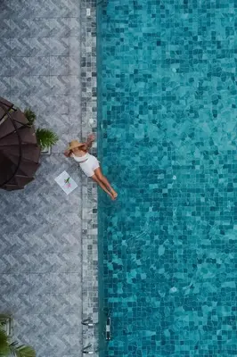 a woman is swimming in a swimming pool at Chanakarn Pool Access Rawai in Rawai Beach