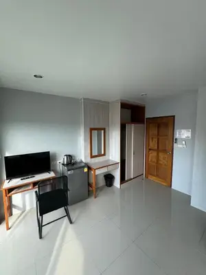 a room with a desk and a table and a kitchen at ZEN Hotel Patong Beach -ex- miami Production in Patong Beach
